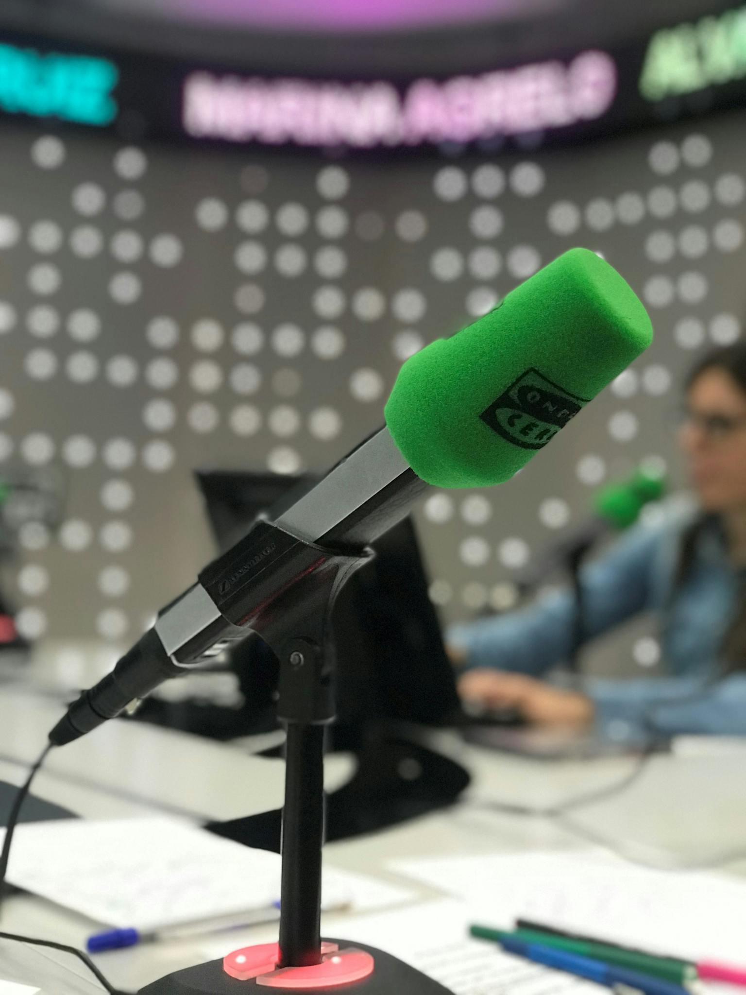 Green microphone in a Madrid radio station studio focused in a broadcast session.